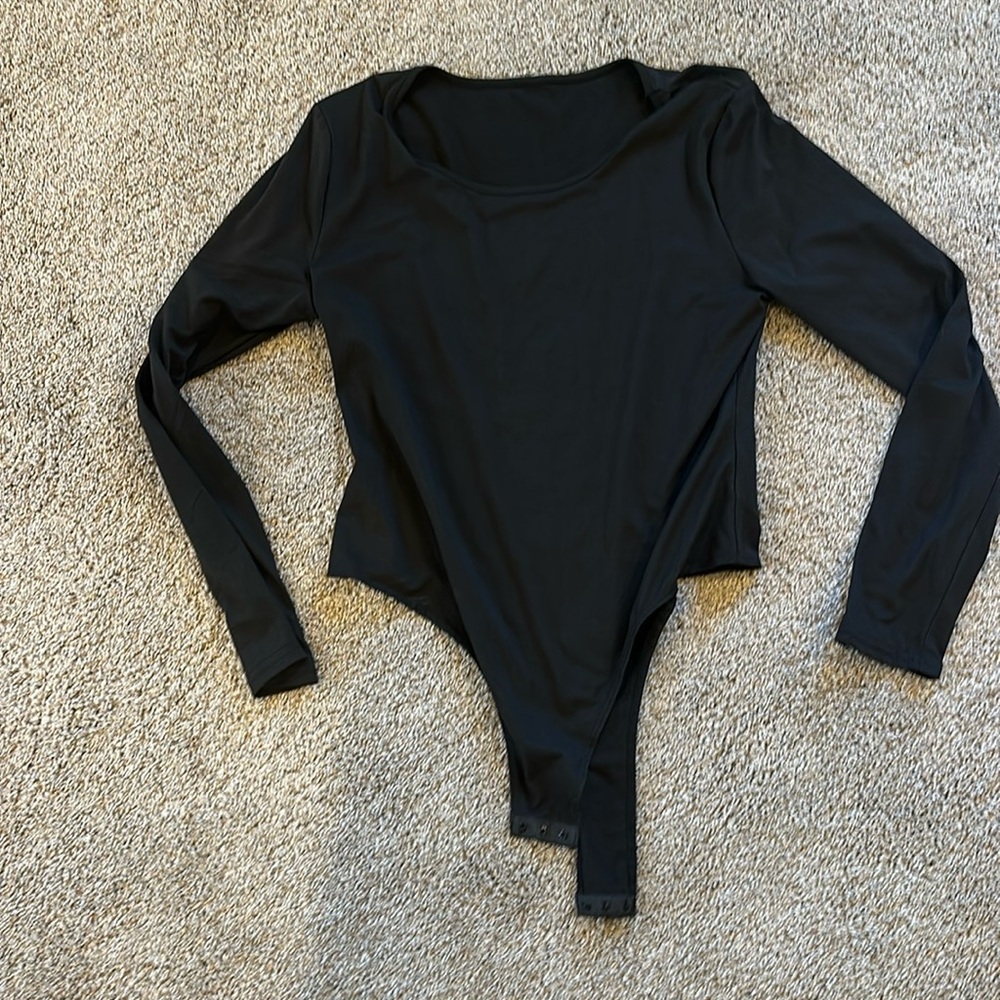 Black bodysuit with snaps. Size extra extra large, but fits more extra large.